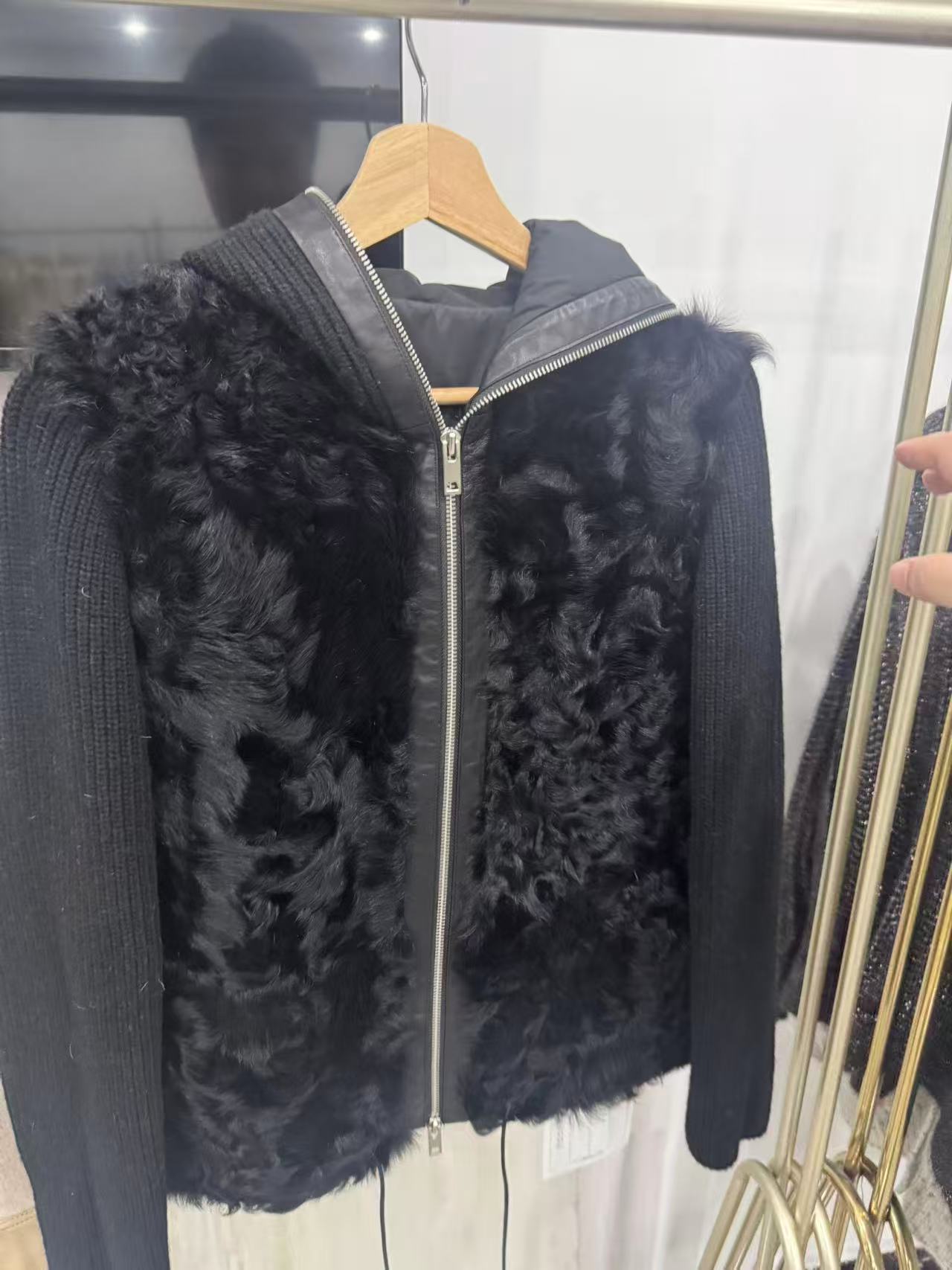 Black hooded zip sample with knitted sleeves and a fur-like front panel